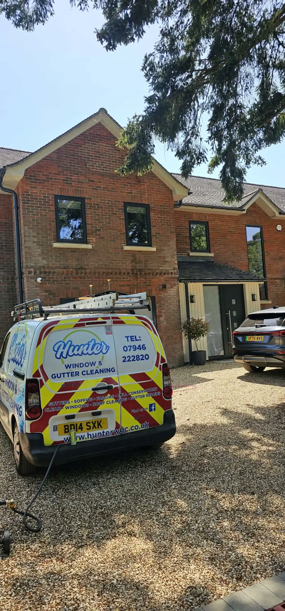 Hunter WGC van parked on a customer's driveway in front of a brick house